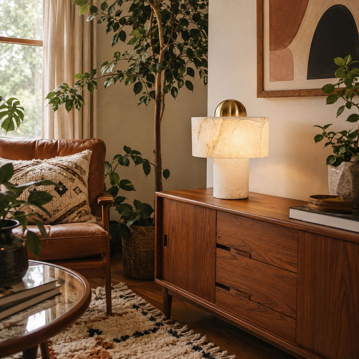 Spanish alabaster table lamp glowing on mid century wooden sideboard in cozy living room with plants