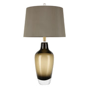 Art glass table lamp with amber gradient base and grey fabric shade turned off on white background