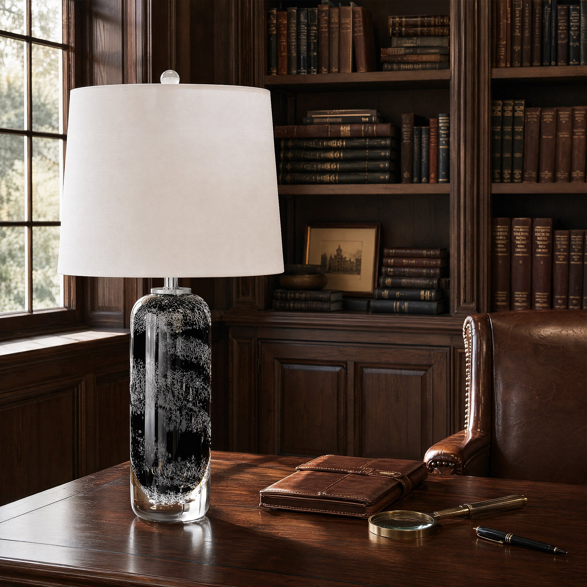 Art glass table lamp displayed on a rich dark wood executive desk in a classic home library office setting.