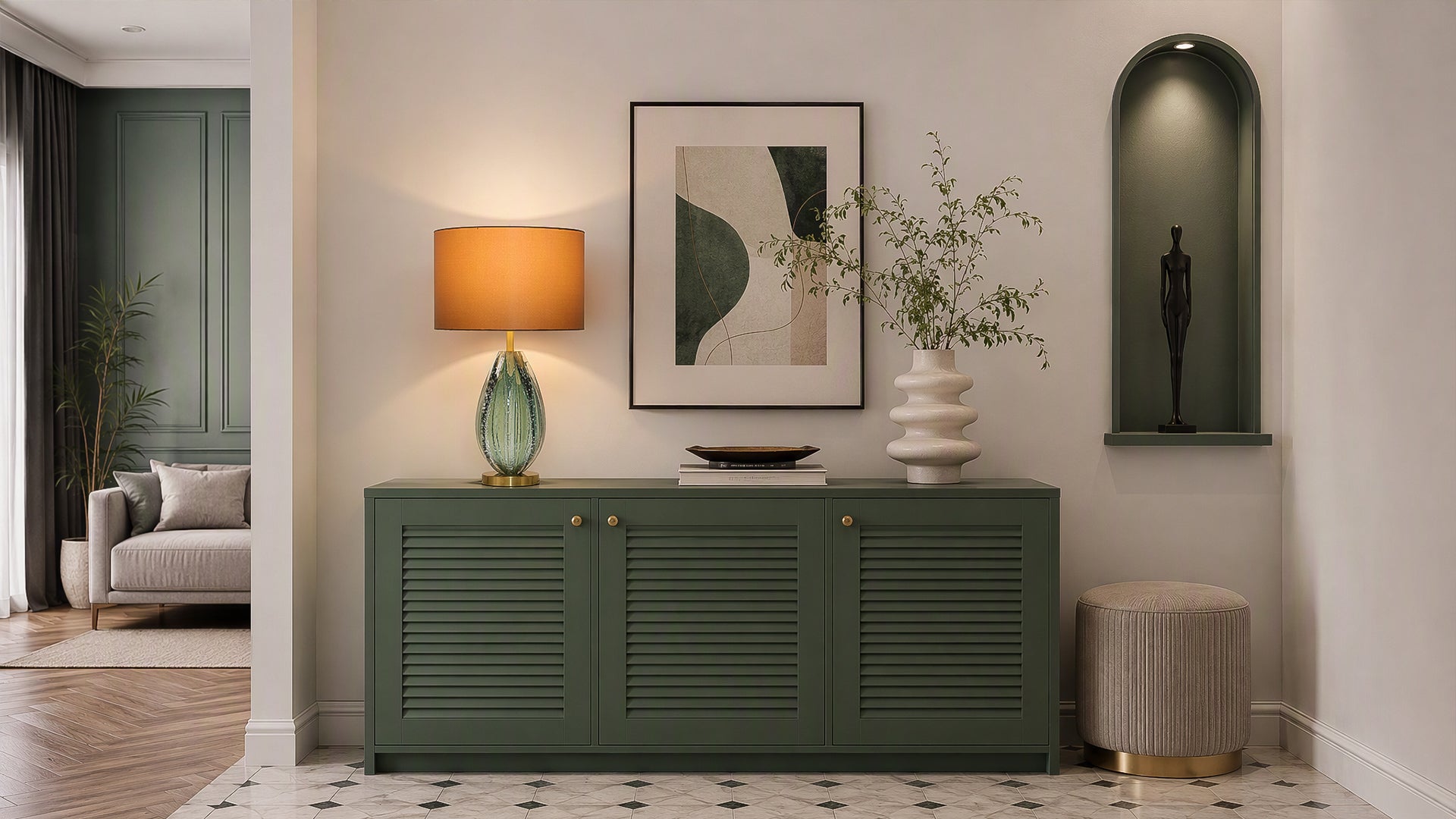 Illuminated art glass table lamp with brown fabric shade on dark green credenza in stylish entryway foyer