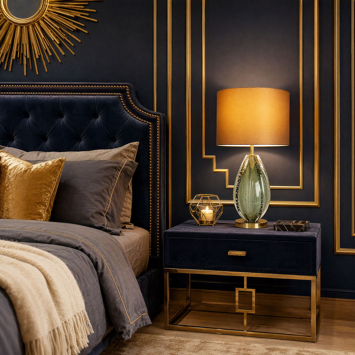 Illuminated art glass table lamp with teardrop teal seeded glass base on navy velvet nightstand in luxury dark bedroom