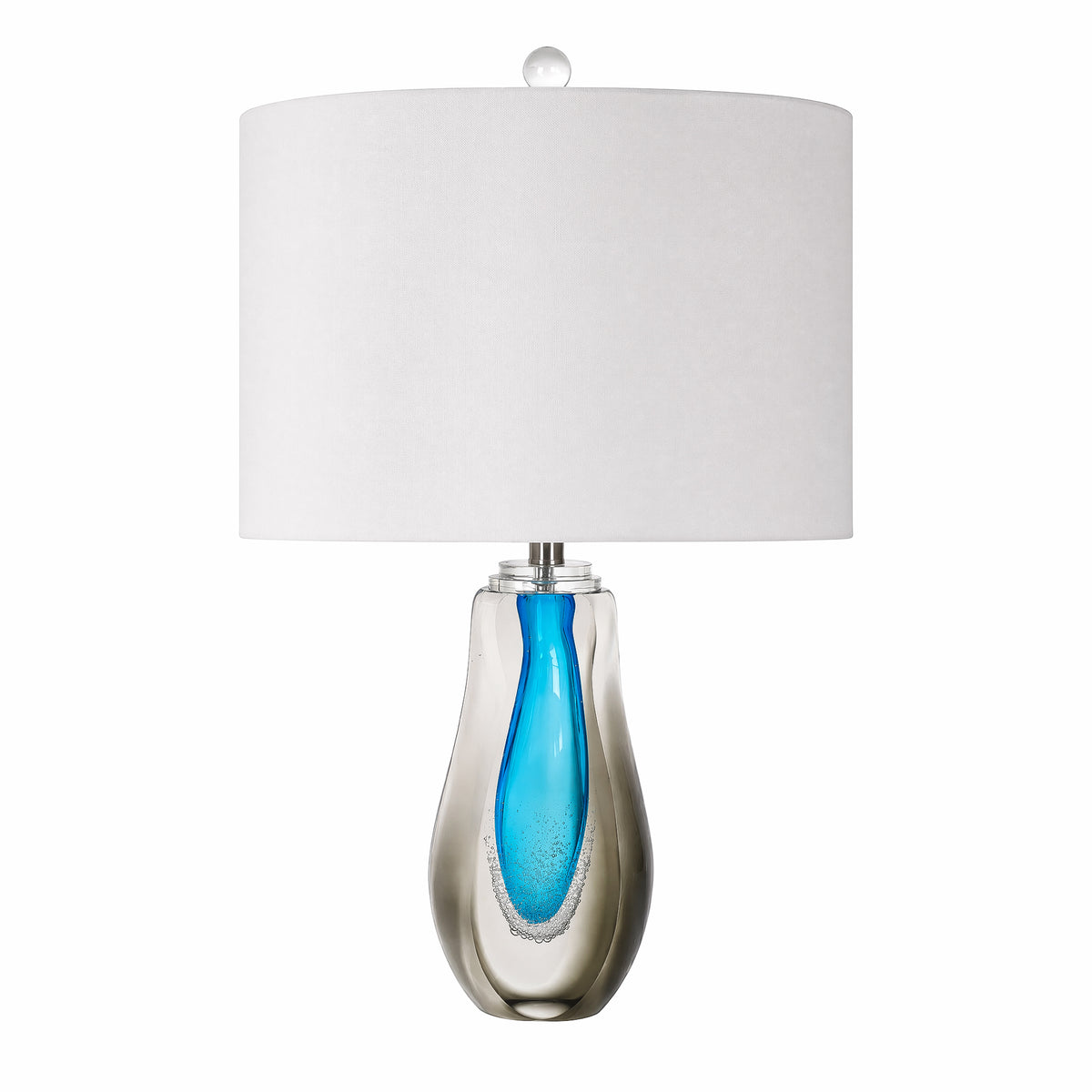 Art glass table lamp with clear smoke outer glass and vibrant blue teardrop inner core on a plain background