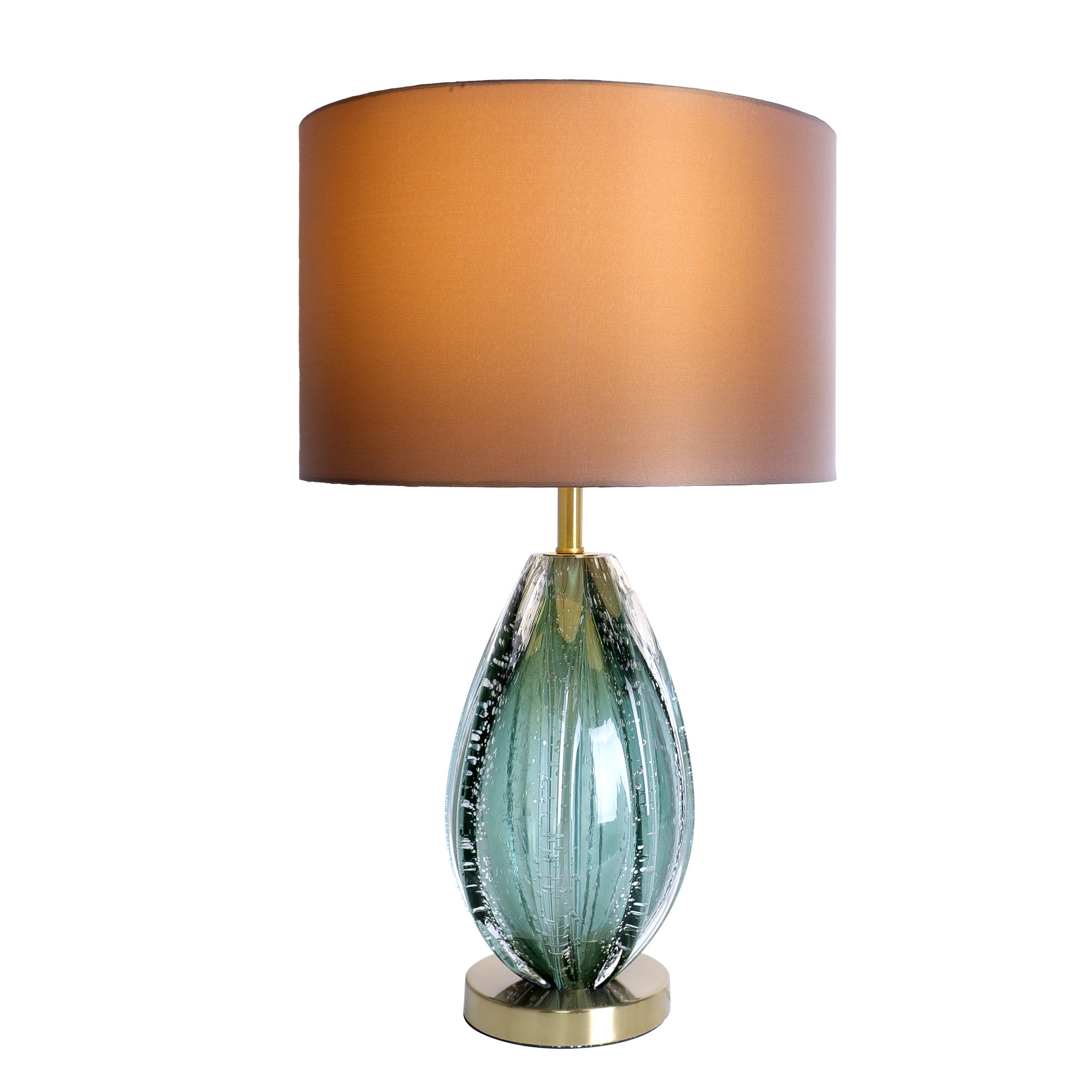 Illuminated art glass table lamp with teal seeded glass body glowing under brown fabric shade on white background