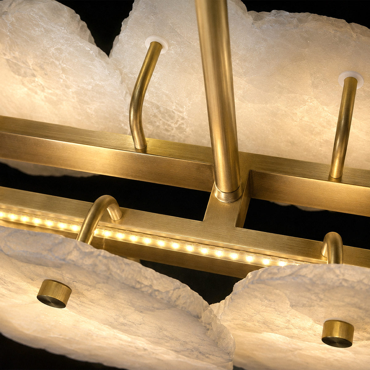 Detailed view of solid brushed brass internal frame with integrated LED light strip and attached alabaster diffusers