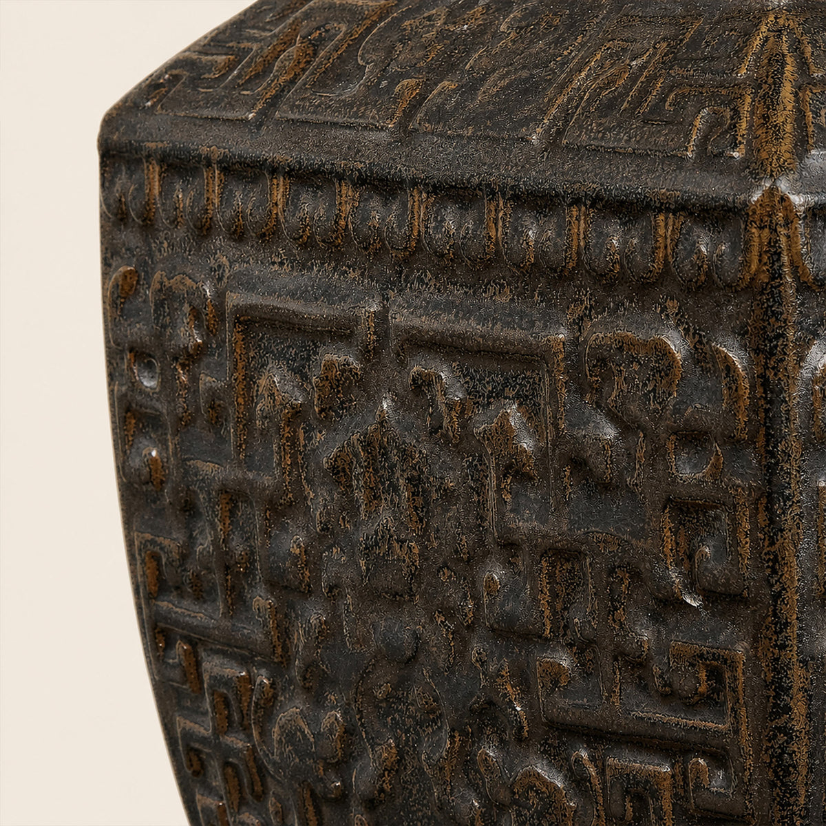 Close up detail of dark bronzed ceramic table lamp base showing intricate carved relief texture and antiqued ceramic glaze