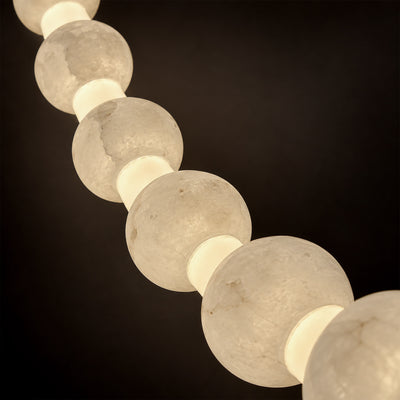Close up view of translucent Spanish alabaster spheres showing delicate cloud veins and soft warm light glow