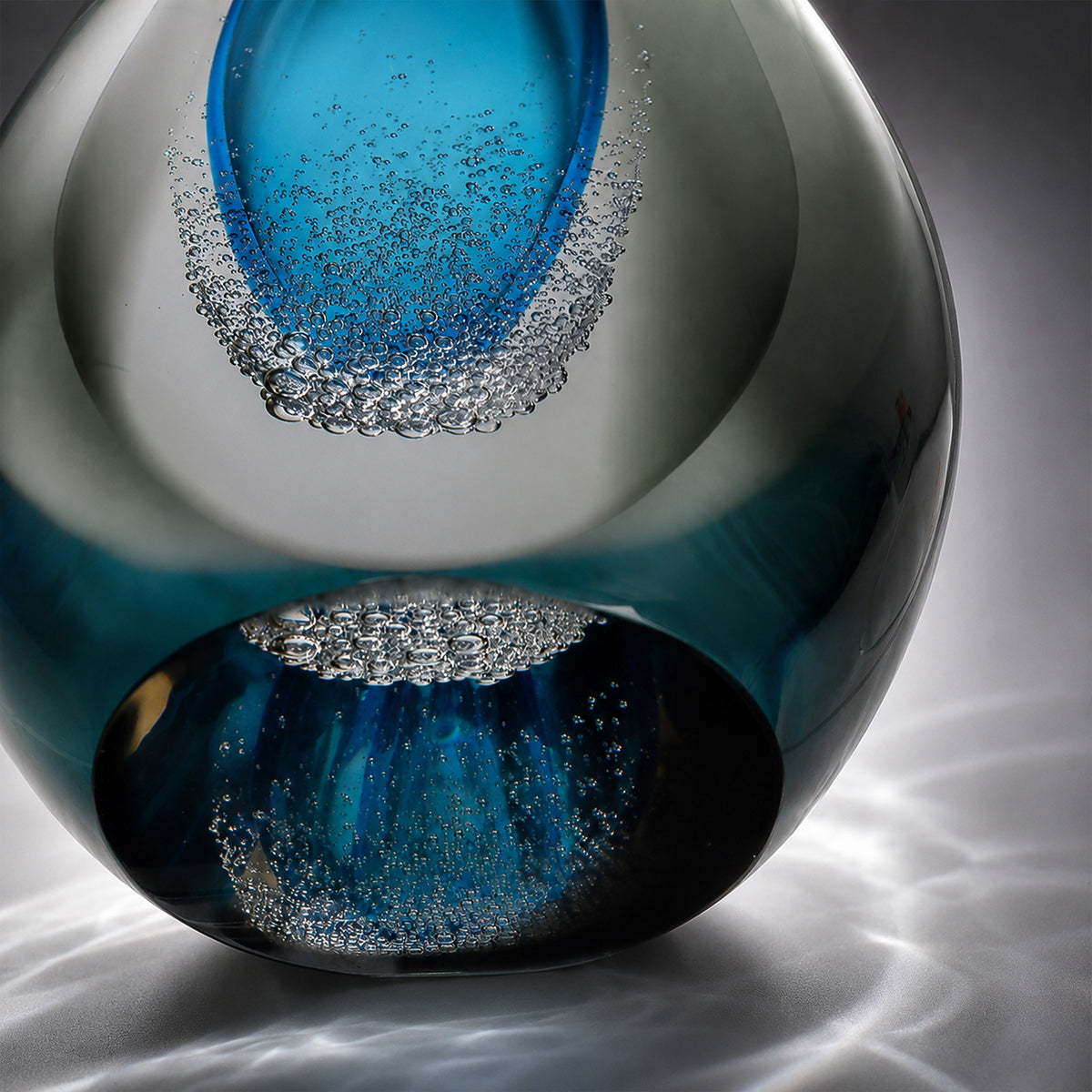Close up view of the glass lamp base showing delicate bubble textures and natural light refraction