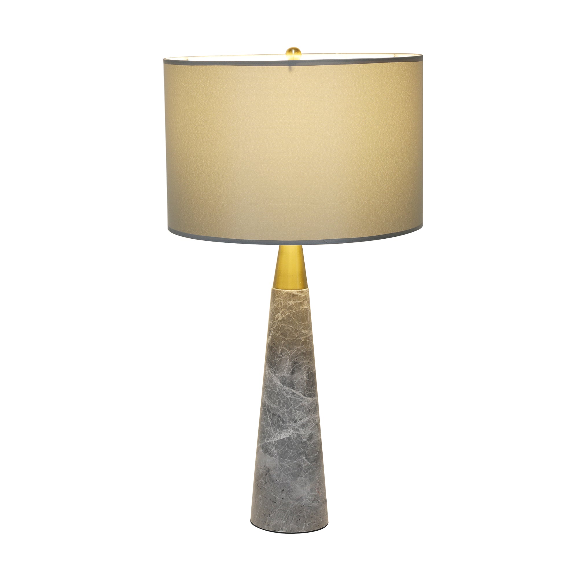 Illuminated grey marble table lamp glowing warm light under grey shade on white background