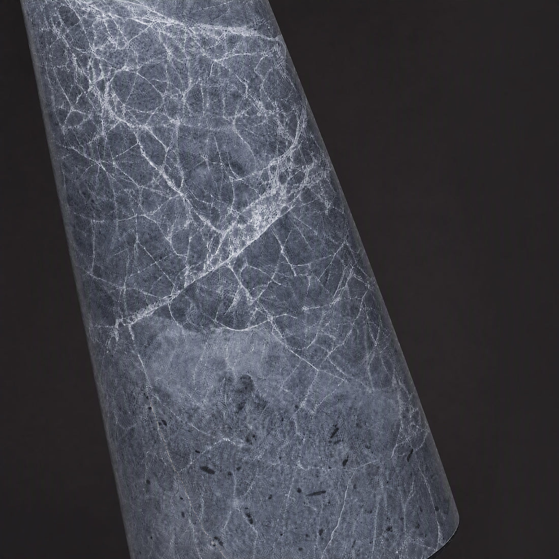 Extreme close up detail of grey natural marble base showing white intricate vein patterns