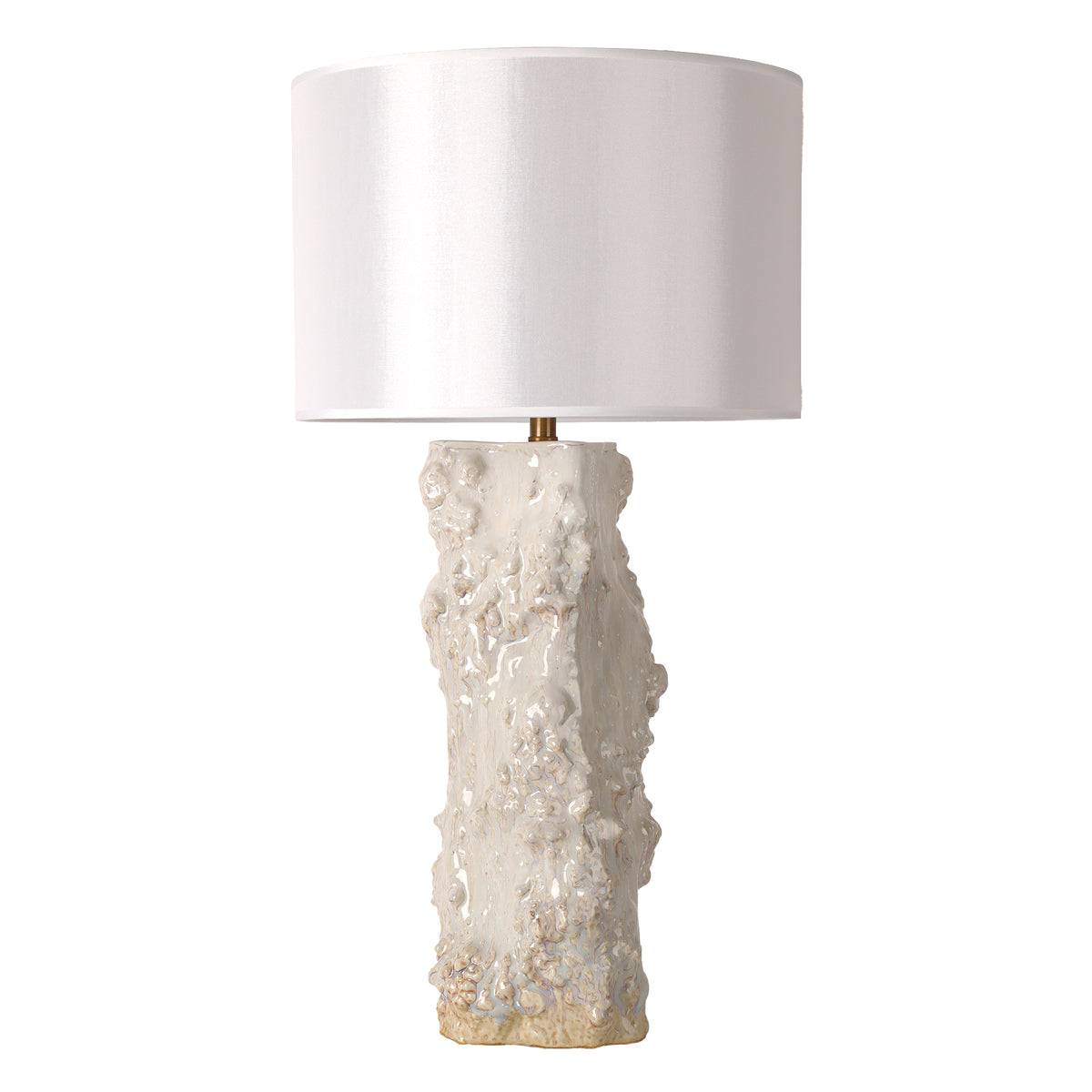 Handmade vintage organic textured ceramic vessel table lamp with white drum shade turned off on white background