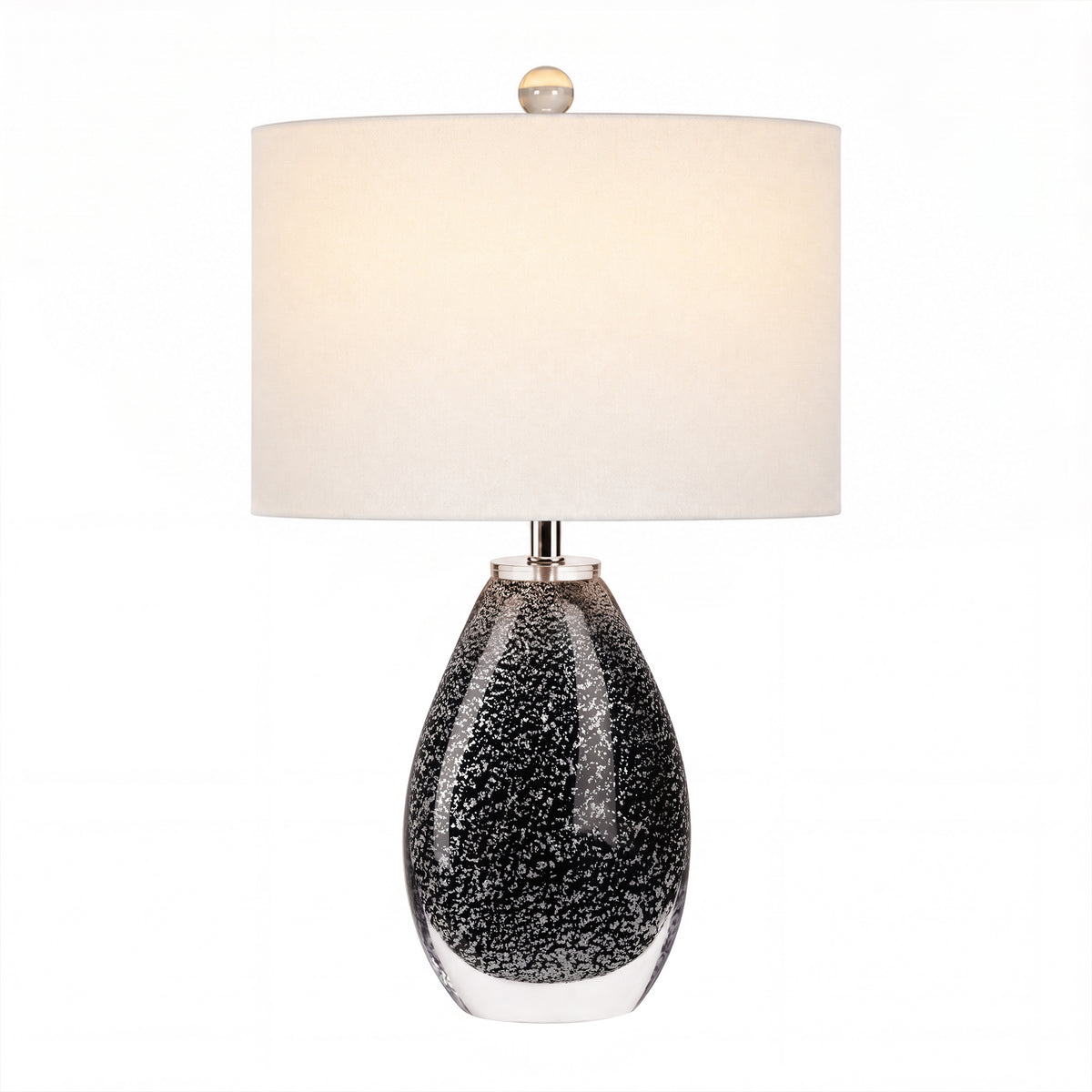 Warm illuminated smoke gray bubble glass table lamp with brass hardware and white shade on white background
