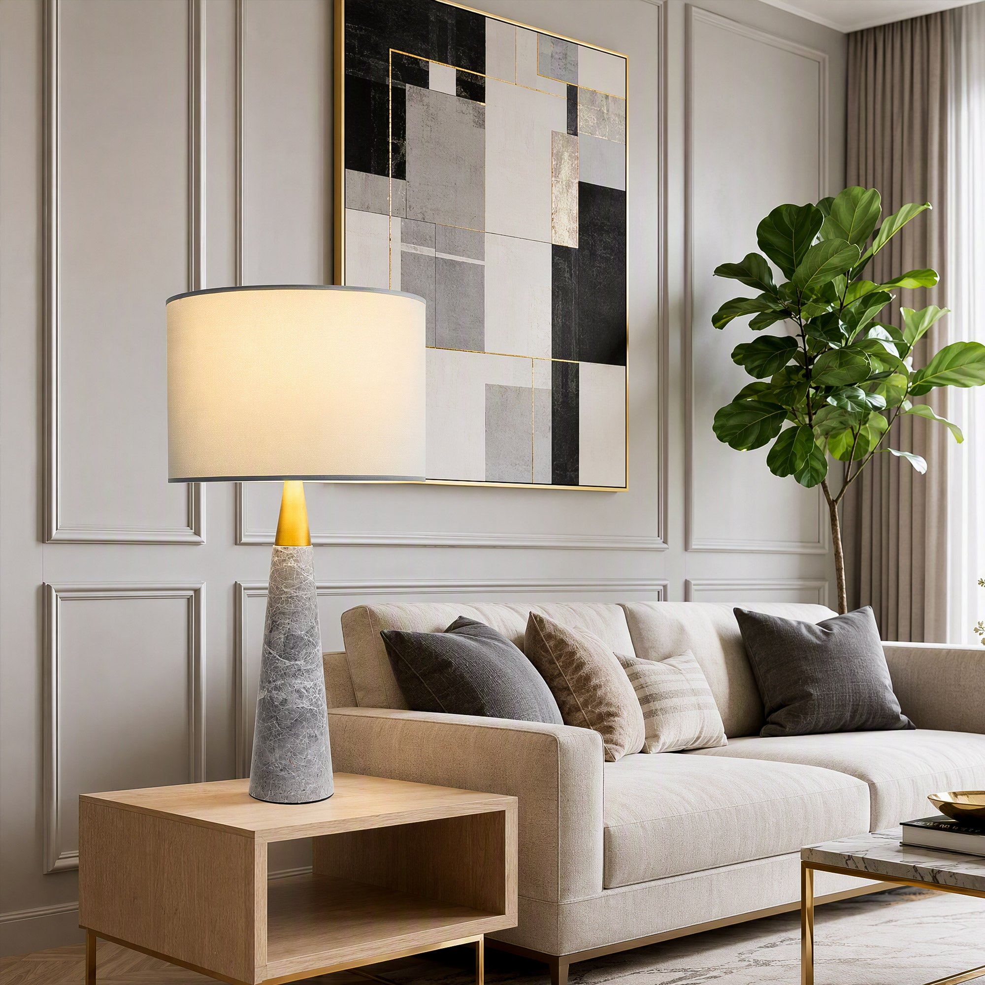 Illuminated grey marble table lamp on wooden side table beside cream sofa in bright living room