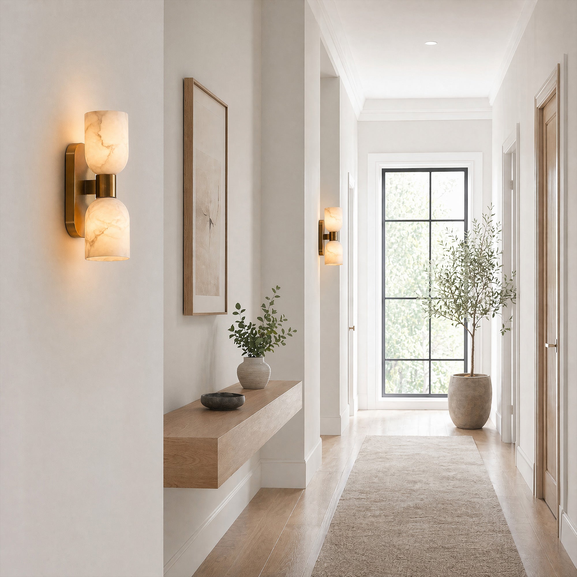 A long, bright organic modern hallway featuring multiple cup-shaped alabaster wall sconces illuminating a floating wooden bench, leading towards a large window with an olive tree.