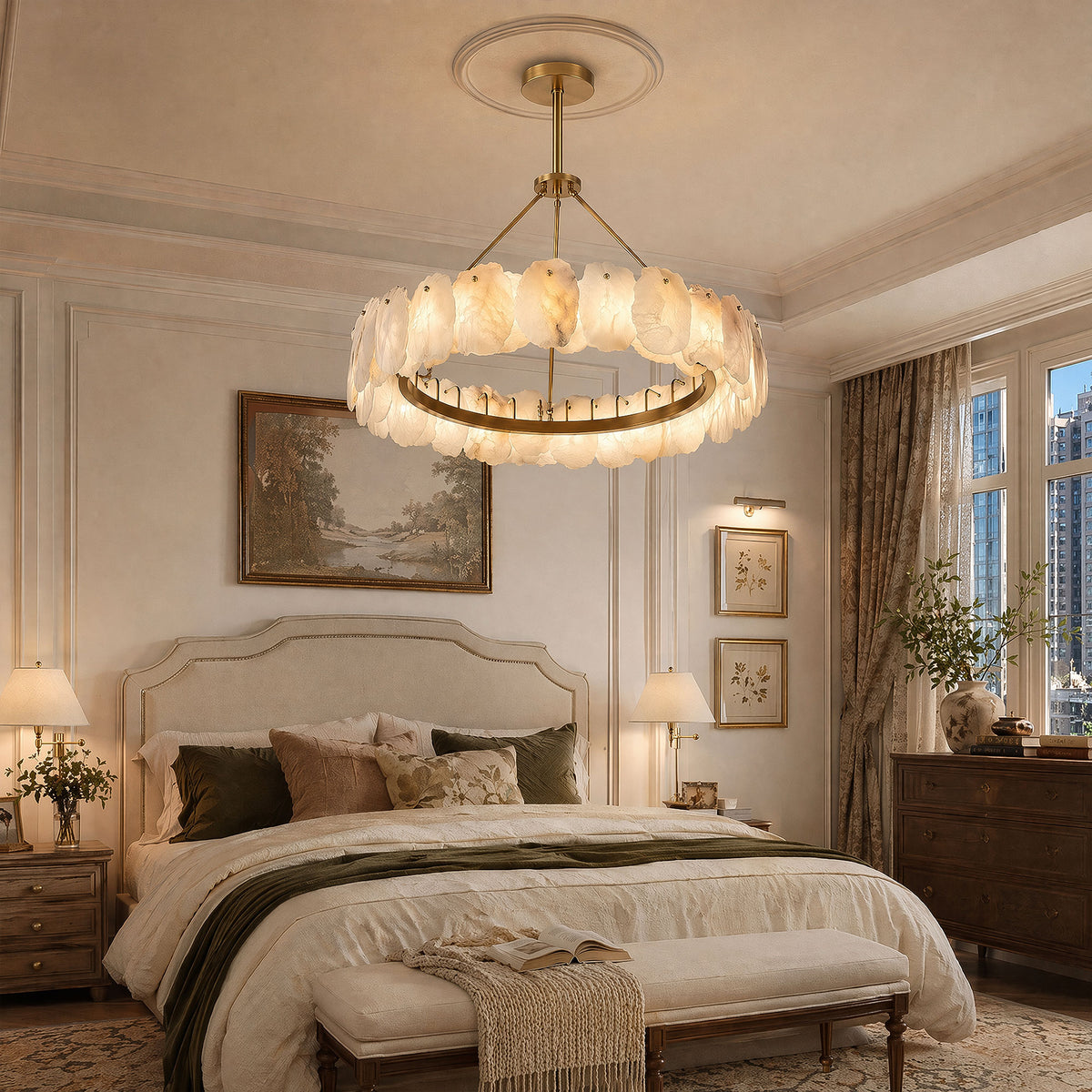 A high end French provincial style master bedroom suite featuring a plush upholstered bed and a statement organic modern round alabaster ring chandelier hanging from the ceiling center.