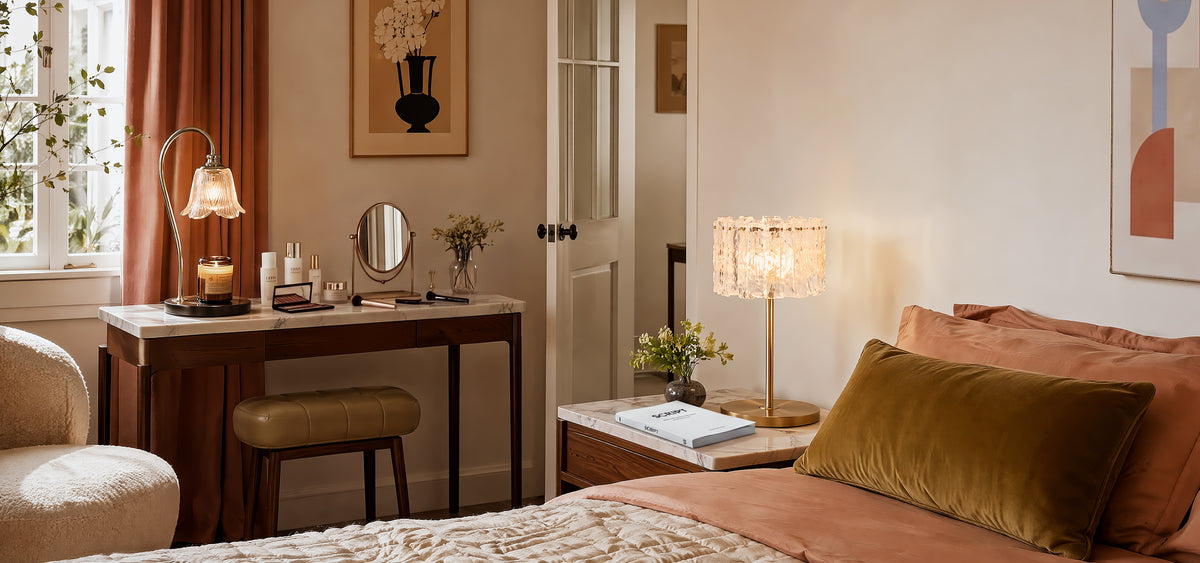 A cozy mid-century modern bedside setup featuring a luxury crystal and solid brass table lamp casting warm, refracted light, paired with a vintage iron desk lamp in a moody bedroom.