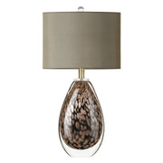 A premium hand blown glass table lamp with a dark olive drum shade showcasing its unique natural gold brown mineral scales while turned off on a clean white background.