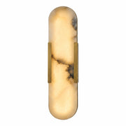 A luxurious capsule-shaped Spanish alabaster wall sconce with a built-in LED light source, flanked by a solid brushed brass frame, illuminated on a white background.