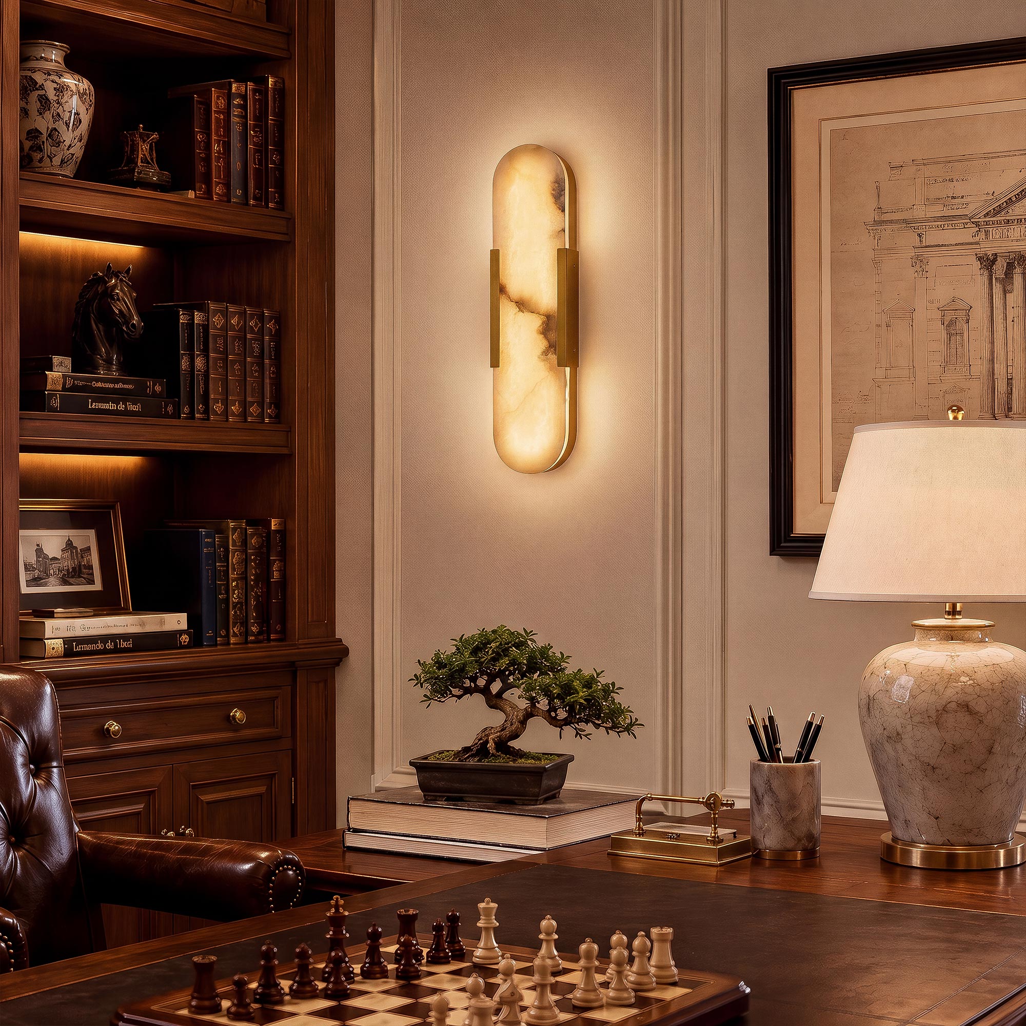 A high-end traditional executive study room featuring a glowing brass alabaster sconce on the wall behind a classic wooden desk set with a chessboard, marble table lamp, and bonsai.