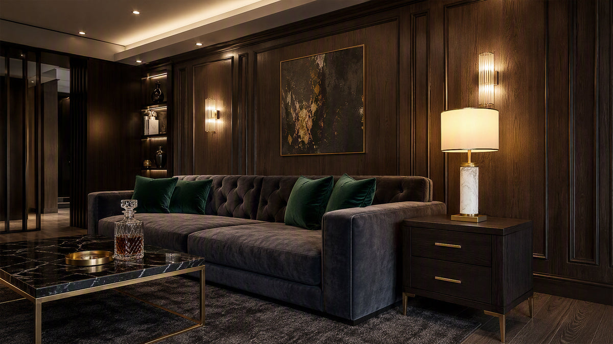 Illuminated white marble table lamp on dark side table in moody luxury living room with Chesterfield sofa