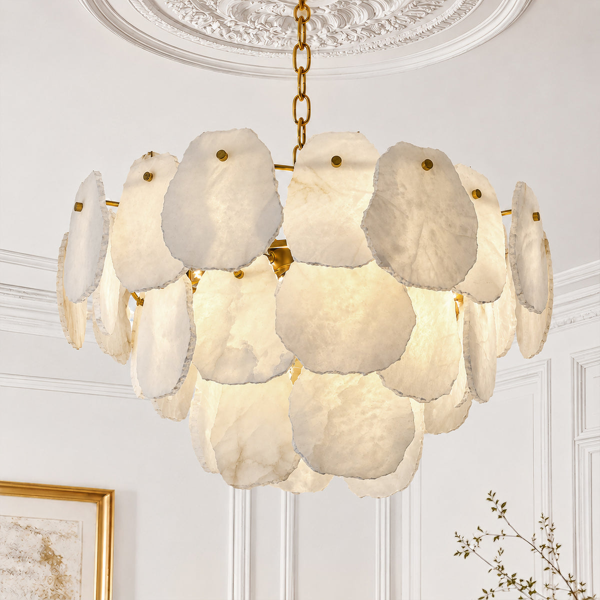 Upward angle detail of glowing Spanish natural alabaster slice chandelier installed under an elegant white ceiling medallion