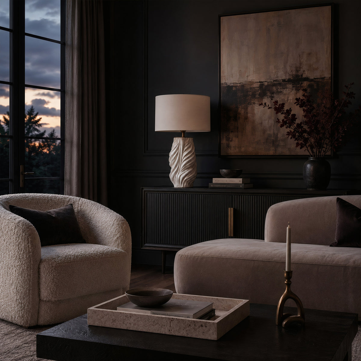 A spiral textured ceramic lamp sitting on a dark wood slatted credenza in a moody contemporary living room by a large window at dusk