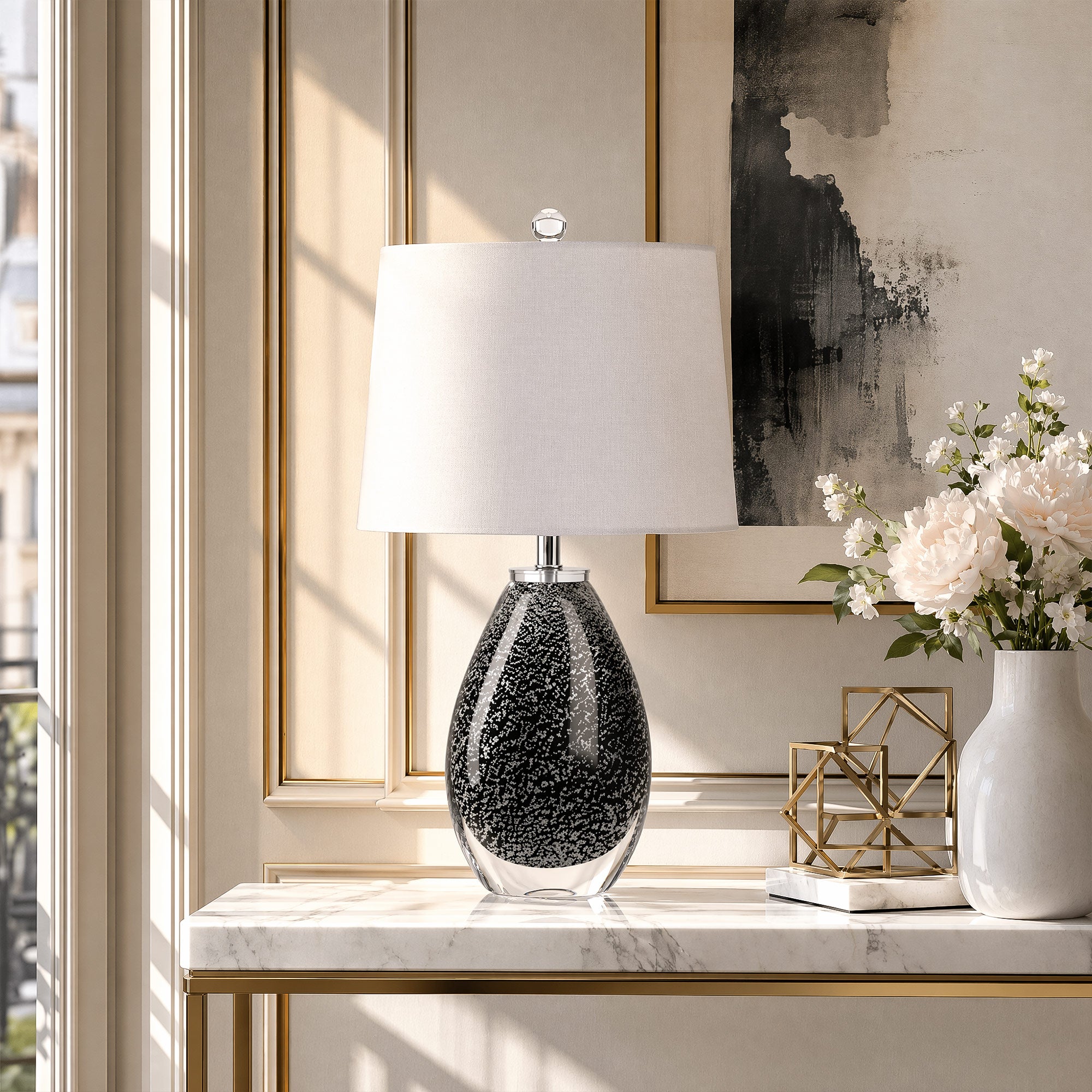 Murano style teardrop black glass table lamp with snowflake pattern on a marble console table in an elegant entryway.