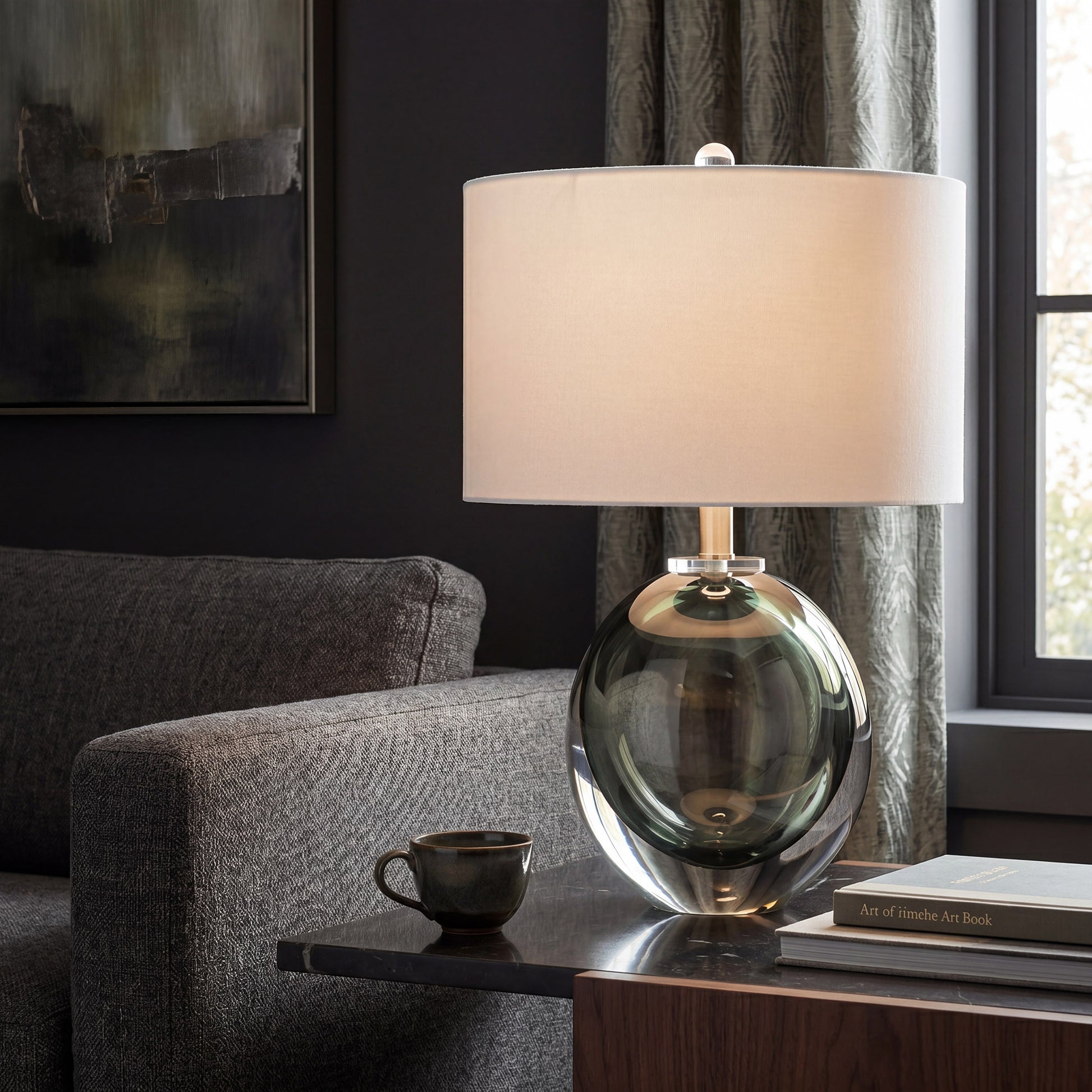 Murano style dark green floating bubble art glass table lamp on a dark side table near window in modern living room.