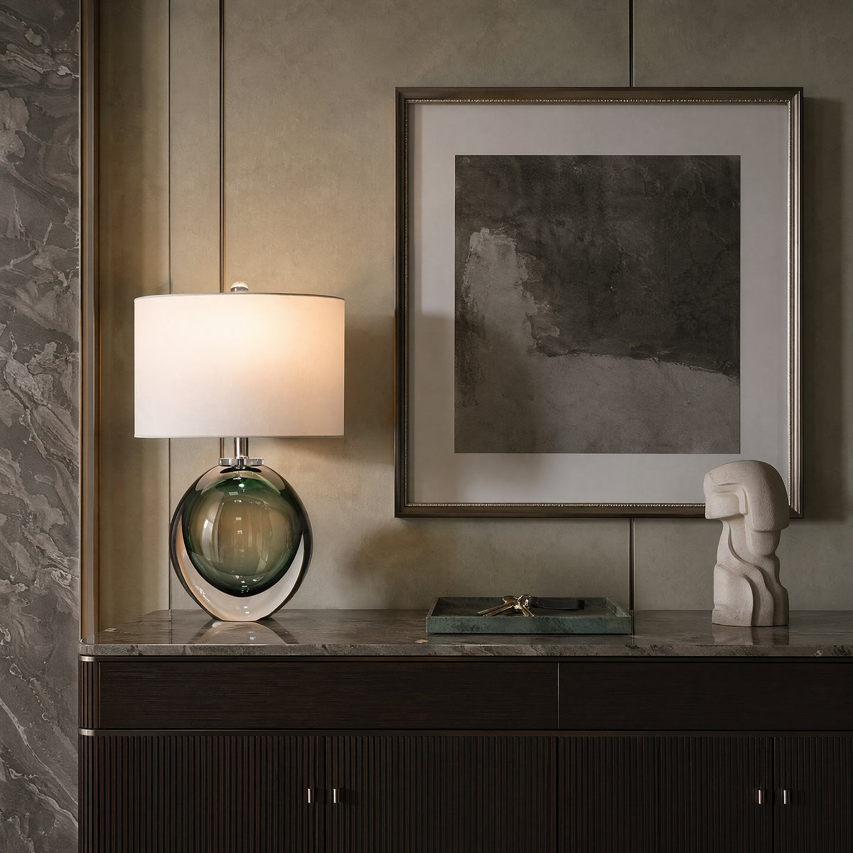 Murano style green bubble glass table lamp placed on a marble top credenza in elegant modern living room.