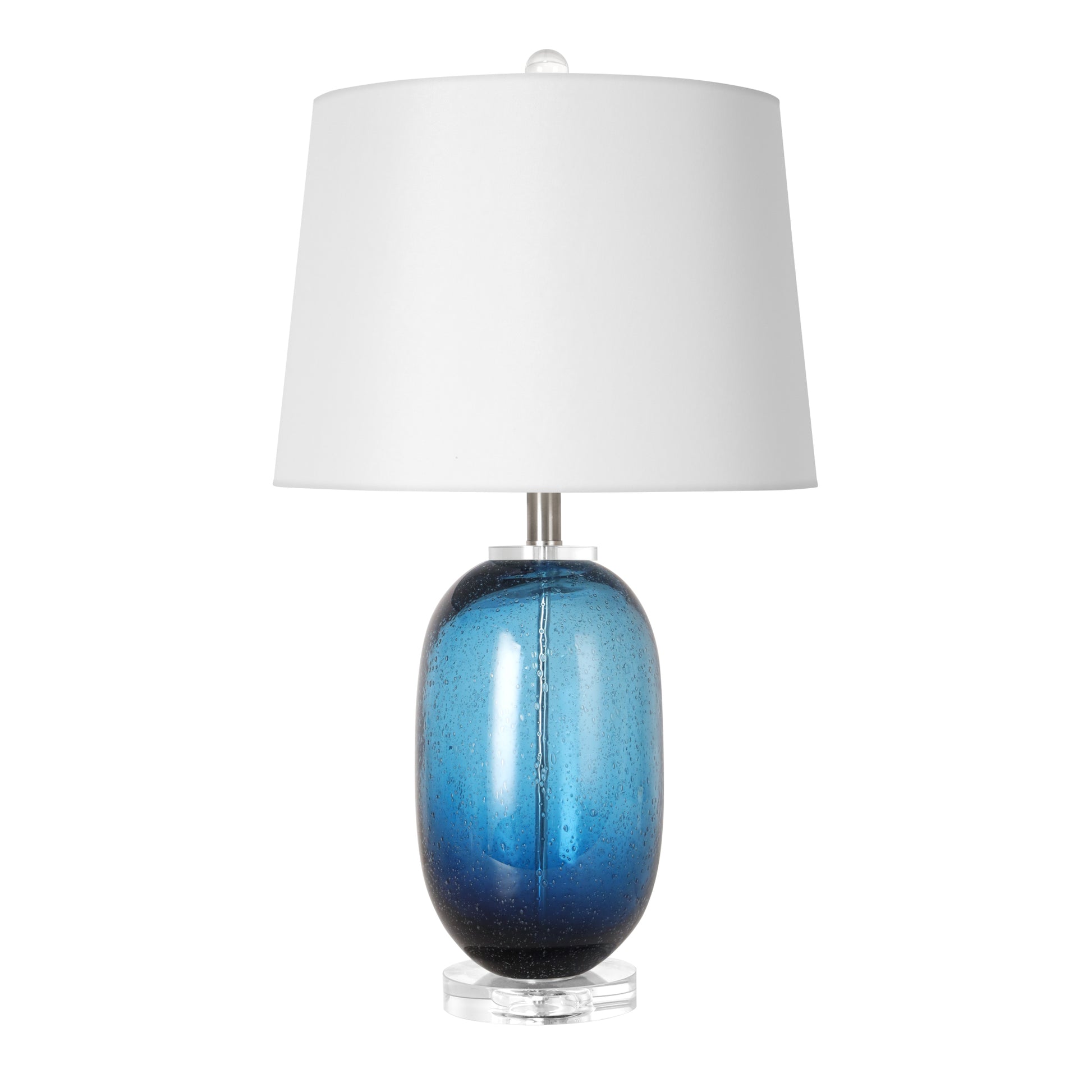 Murano style tall barrel shaped art glass table lamp featuring a thick transparent outer layer and internal floating blue ink bubbles with a white drum shade shown off against a white background