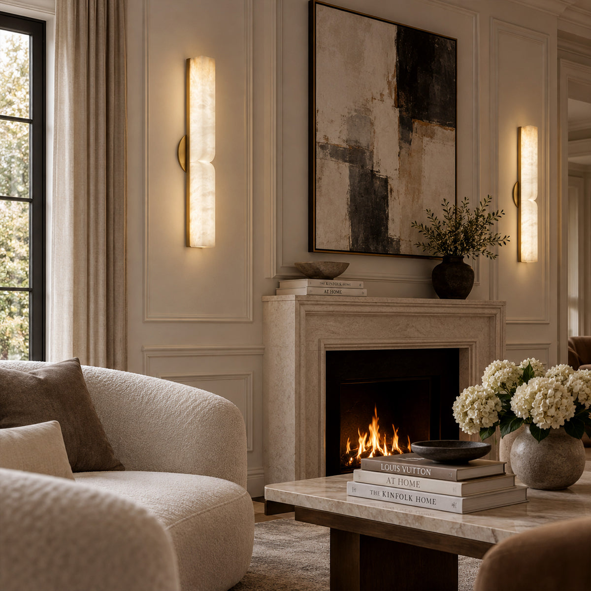 Pair of illuminated long Spanish alabaster wall sconces mounted symmetrically beside a fireplace in a luxury living room