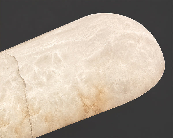Macro view of high quality translucent alabaster stone material emitting a warm ambient glow and showcasing natural veining for high end decorative lighting.