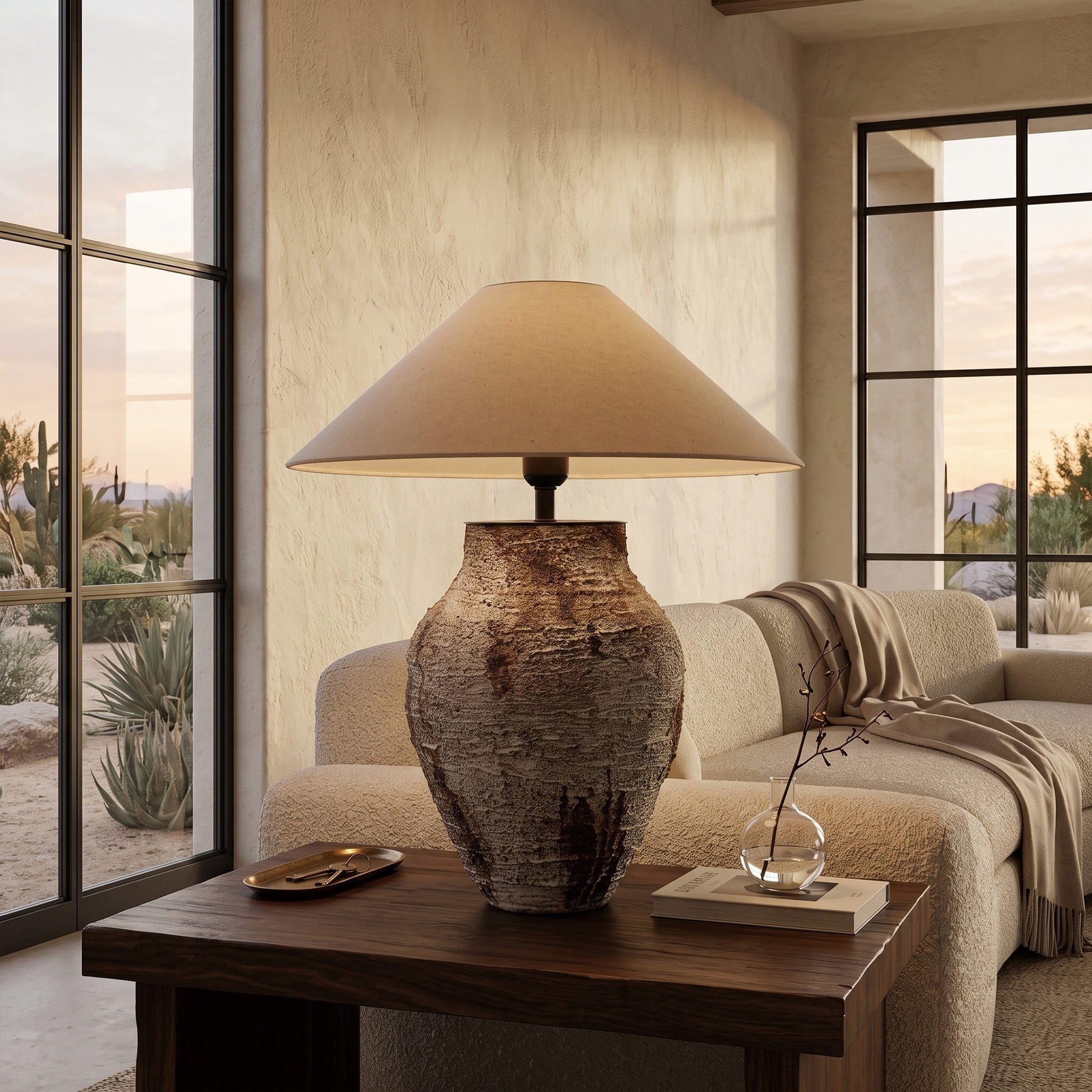 Rustic white textured ceramic table lamp resting on a wooden side table next to a cream fabric sofa.