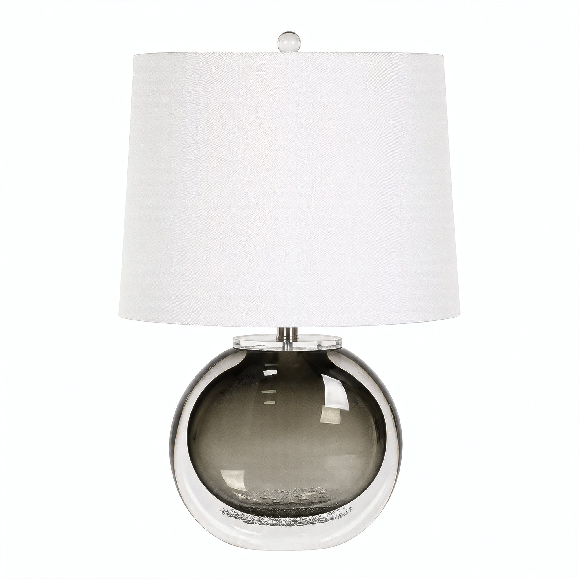 Smoke gray art glass table lamp with clear outer glass layer and white drum shade turned off on white background