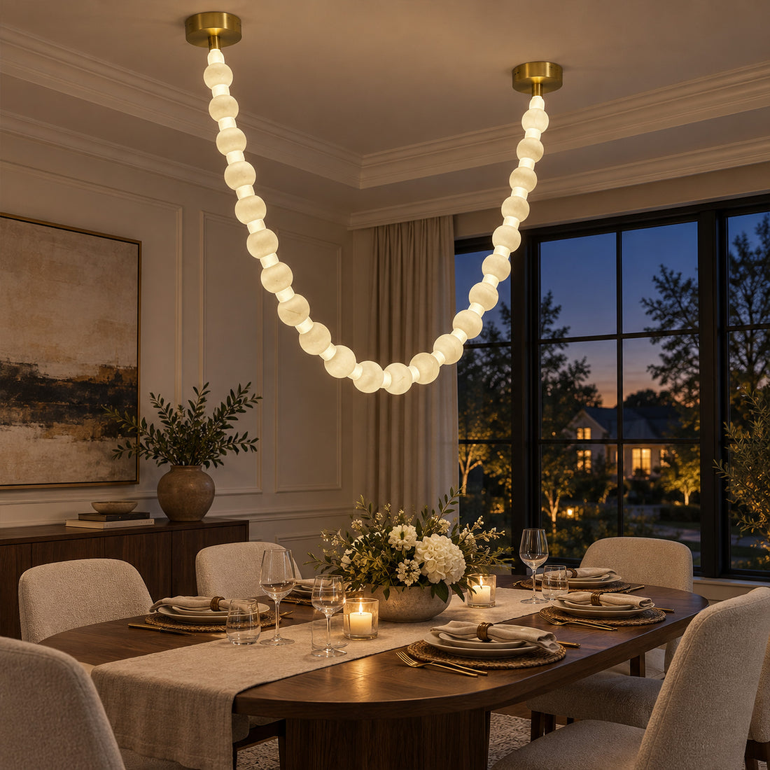 Illuminated Spanish alabaster sphere garland pendant light hanging gracefully above a modern wooden dining table at twilight