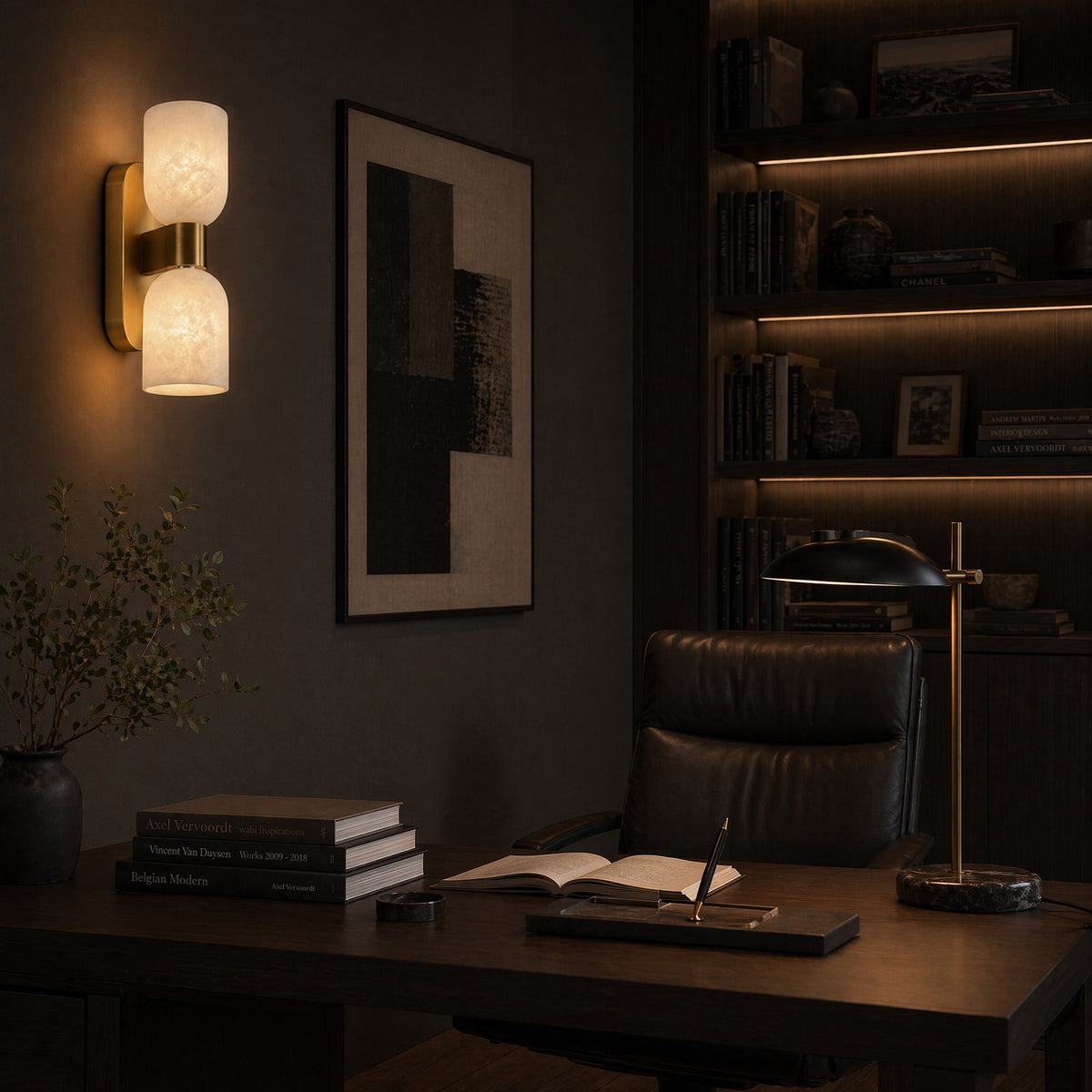 Illuminated double capsule Spanish alabaster wall light mounted beside dark wooden bookshelf and desk in home office