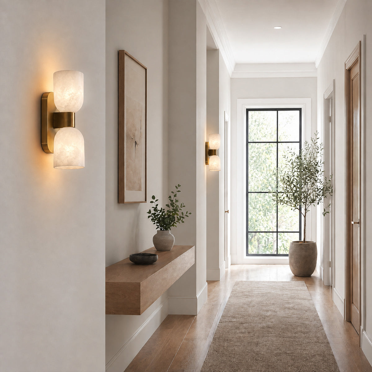 Pair of glowing Spanish alabaster capsule wall sconces lining the wall of a bright home hallway corridor