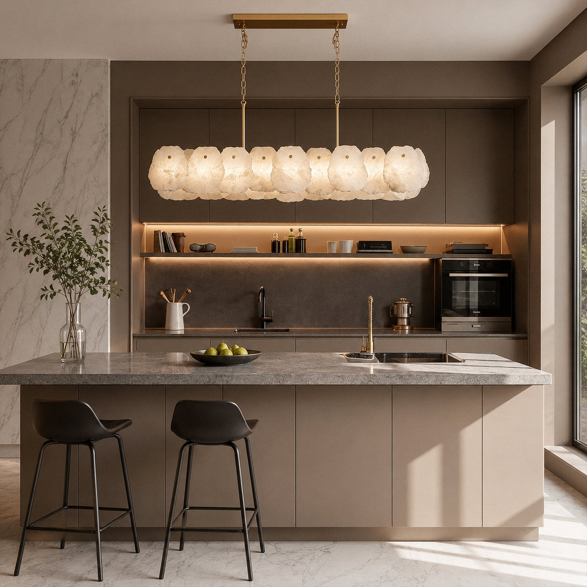 Spanish alabaster linear chandelier glowing bright warm light over modern kitchen island with bar stools