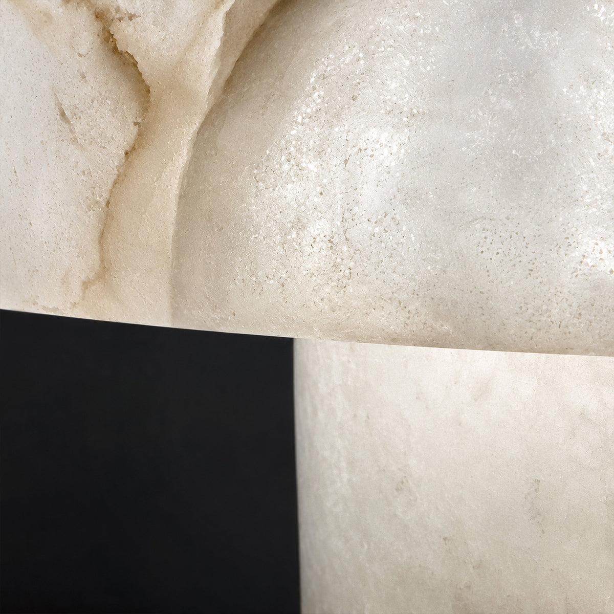 Macro close up of illuminated Spanish alabaster showing natural cloudy grain veins and translucent texture