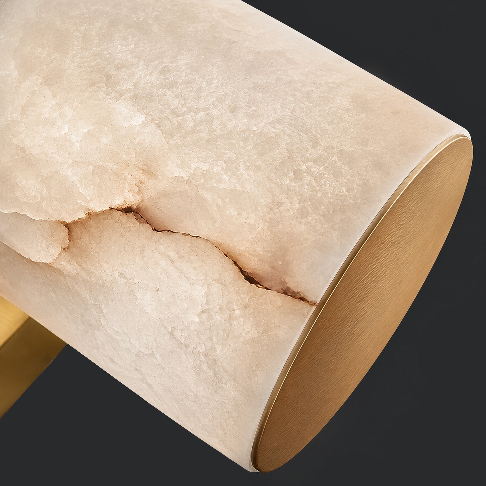 Close up of natural Spanish alabaster texture with distinctive vein pattern and brushed brass metal cap