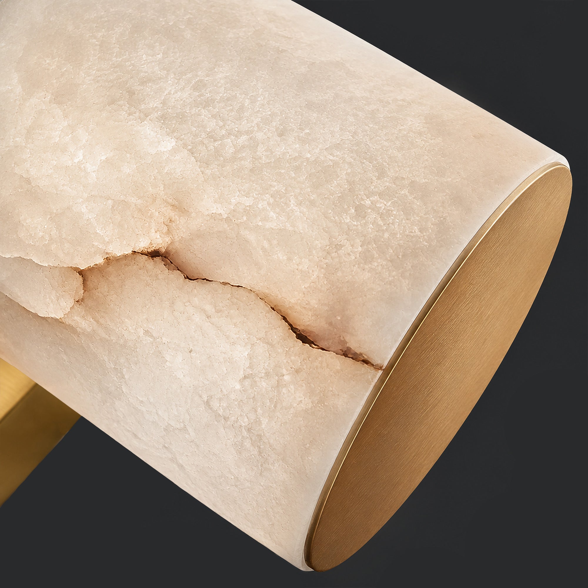 Close up of natural Spanish alabaster texture with distinctive vein pattern and brushed brass metal cap