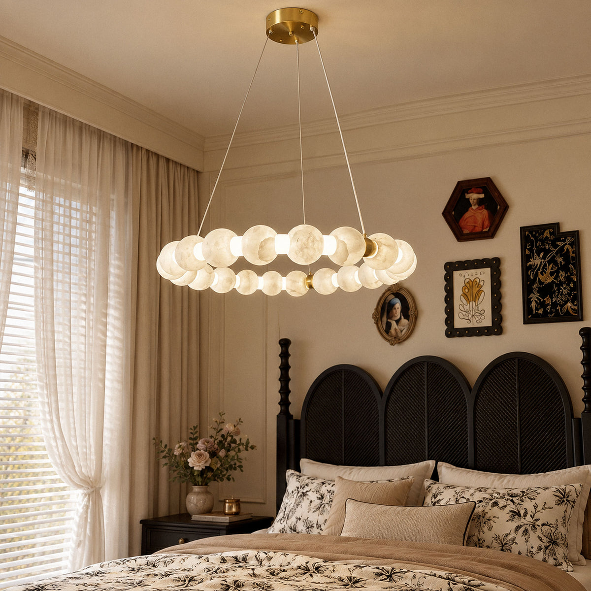 Glowing Spanish alabaster orb chandelier suspended over a modern black headboard bed in a cozy bedroom