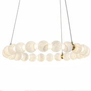 Front view of round chandelier featuring translucent Spanish alabaster orbs on brass frame isolated on white background