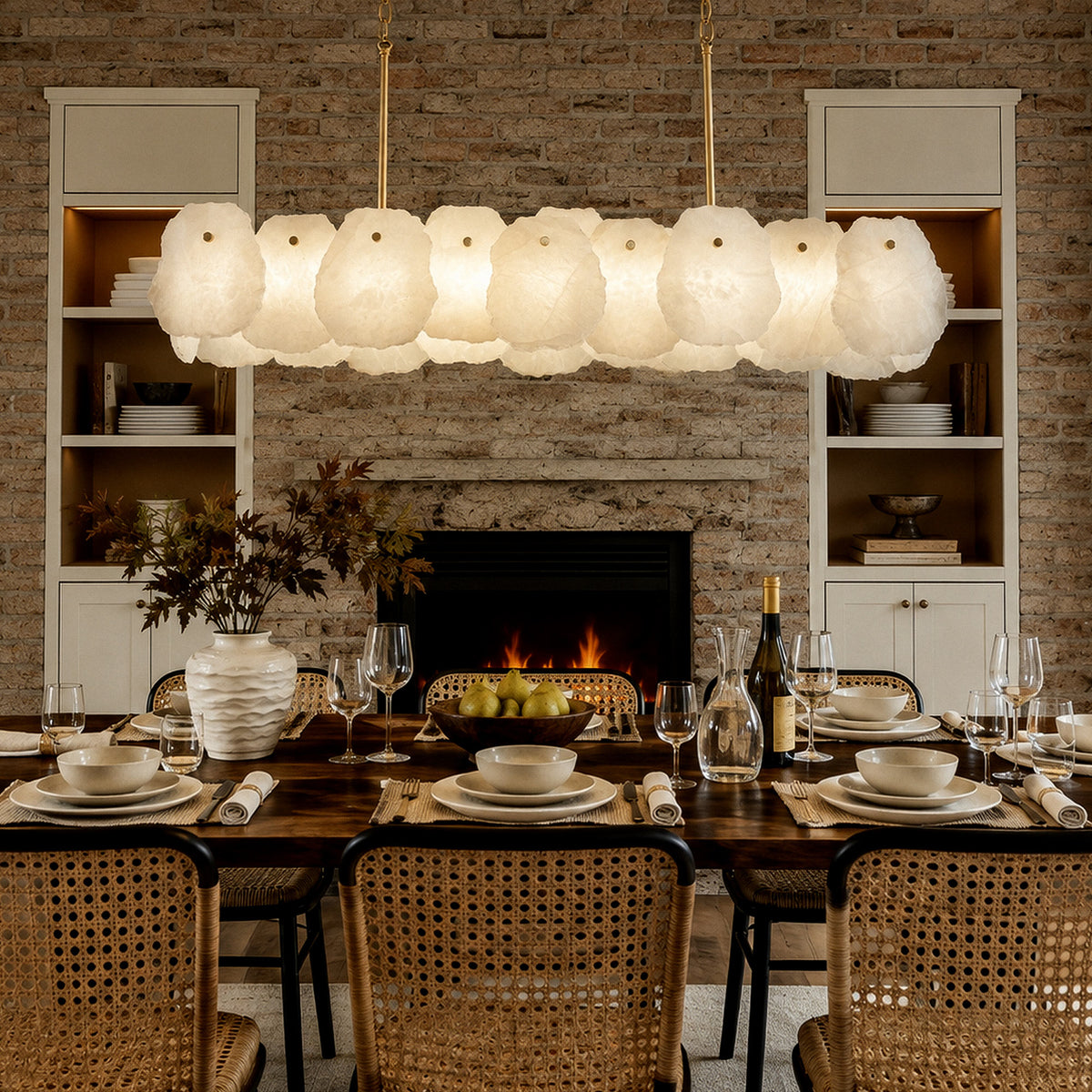 Spanish alabaster pendant chandelier installed above dark wood dining table in brick fireplace farmhouse room