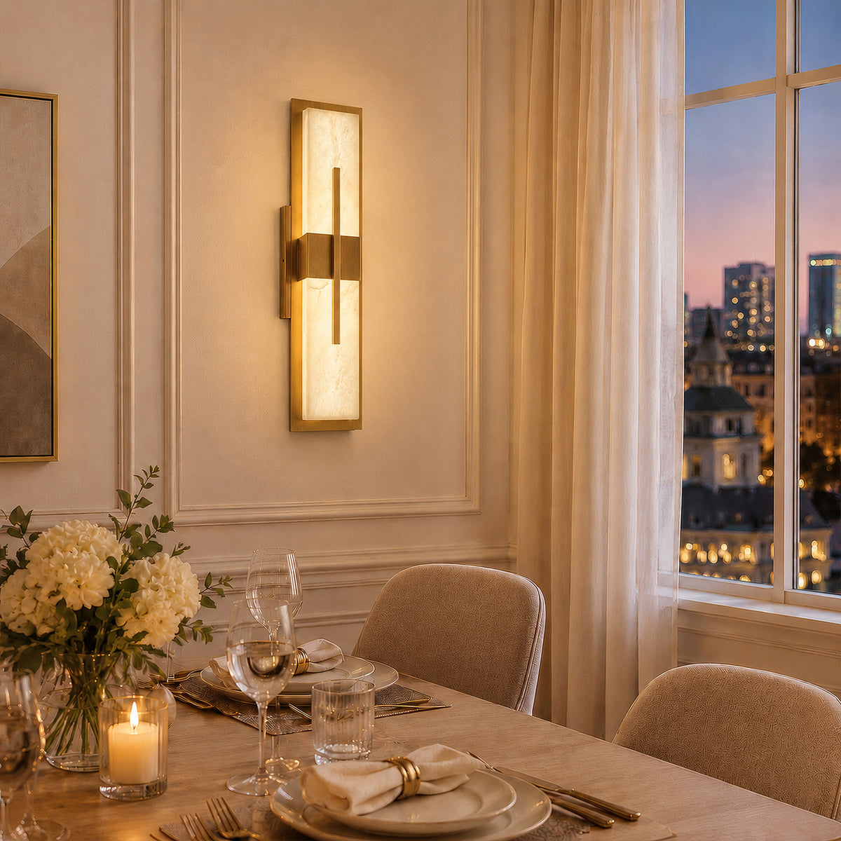 Warmly glowing rectangular natural alabaster wall sconce mounted on white molded wall beside a dining table during evening