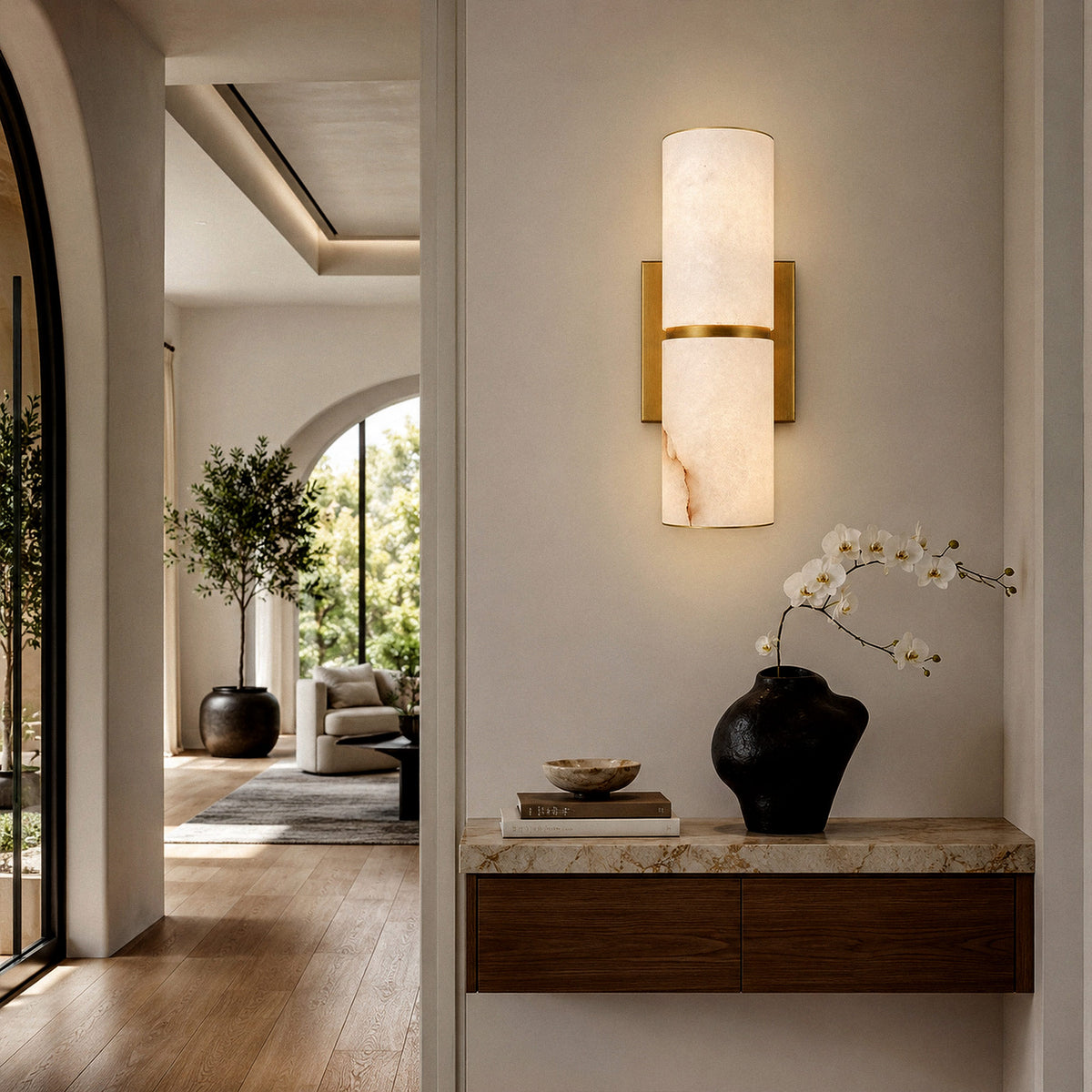 Glowing Spanish alabaster sconce mounted on wall above floating wooden console in modern minimalist foyer