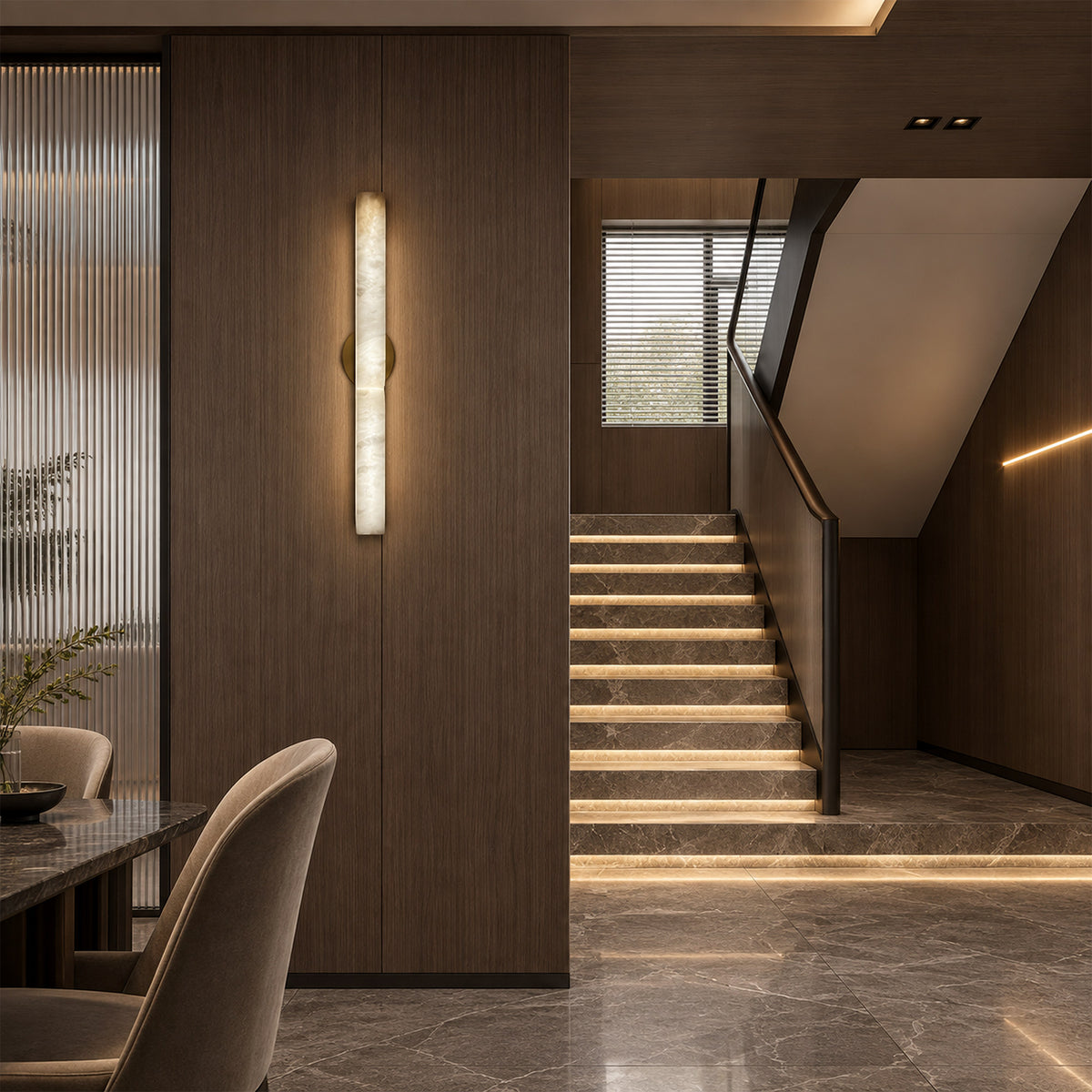 Modern illuminated Spanish alabaster wall light installed on dark wood panel wall in dining area near staircase