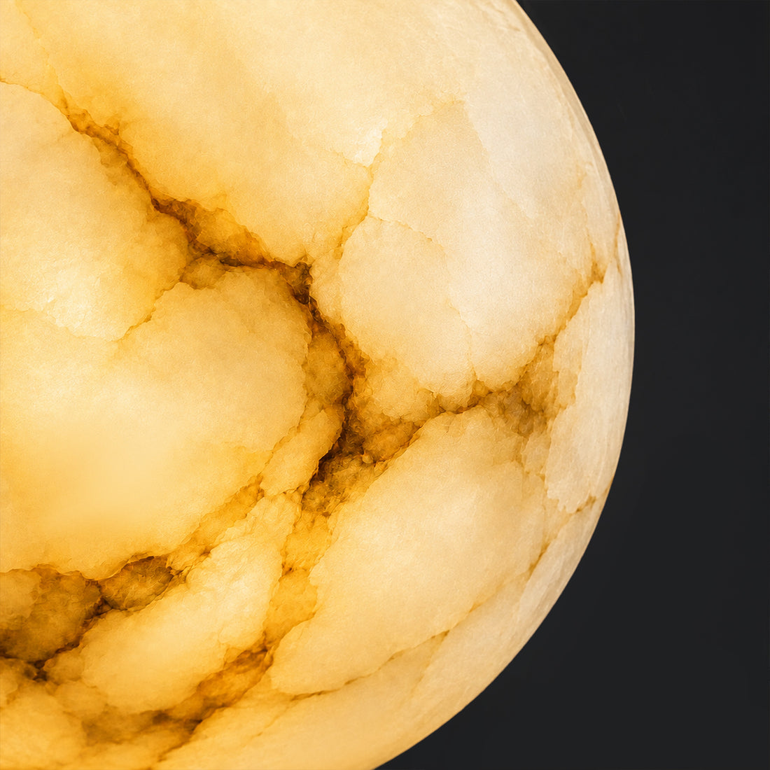 Macro detail close up of glowing natural veins and cloud like translucent texture on a Spanish alabaster sphere shade.