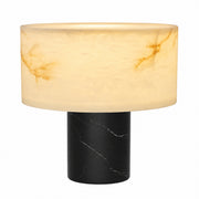 Modern table lamp with translucent white Spanish alabaster shade and cylinder black marble base on white background