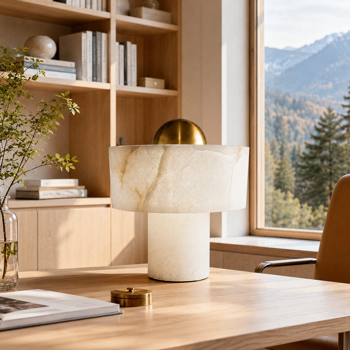 Spanish alabaster table lamp on light oak desk in sunlit modern home office with mountain view