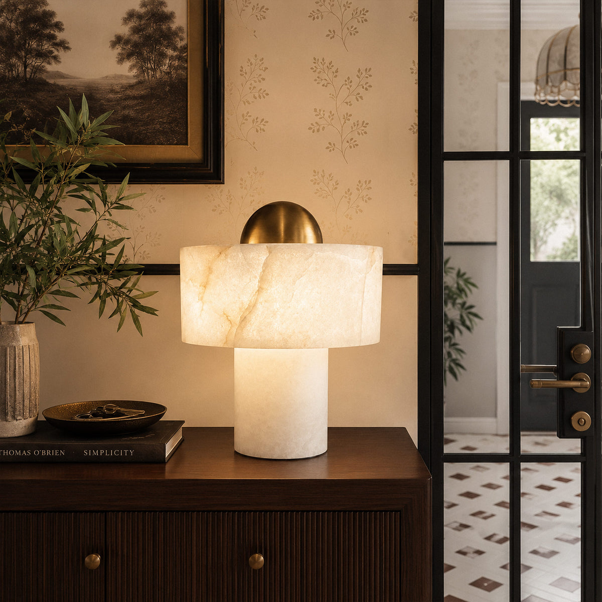 Spanish alabaster table lamp with brass dome lighting warm glow on entryway wooden console table